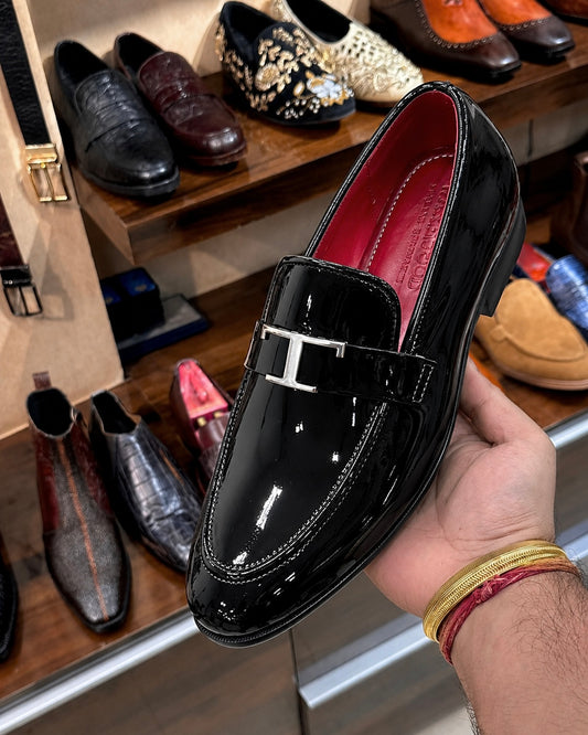 Black Patent Leather Loafers With Silver T Buckle And Red Interior