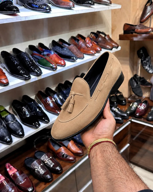 Beige suede loafers with tassels