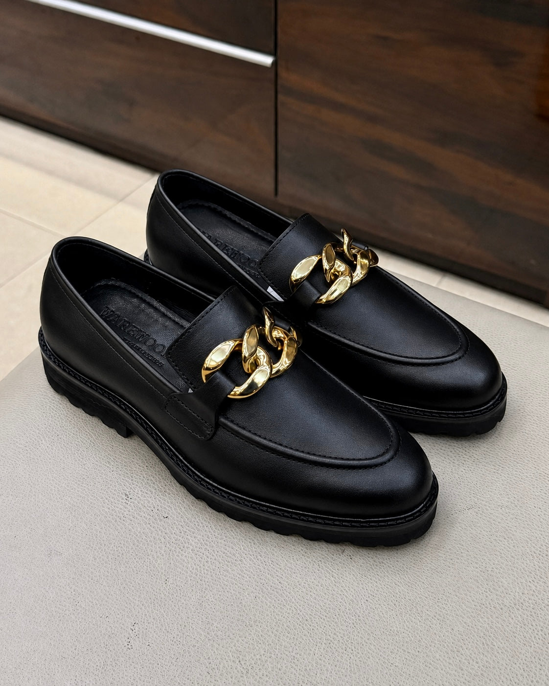 Black chunky loafers with chain