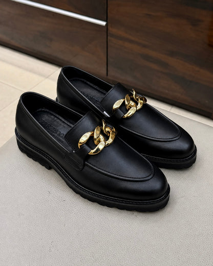 Black chunky loafers with chain