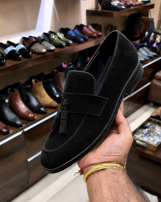 Black suede loafers with tassels