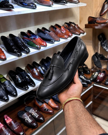Black loafers with tassels