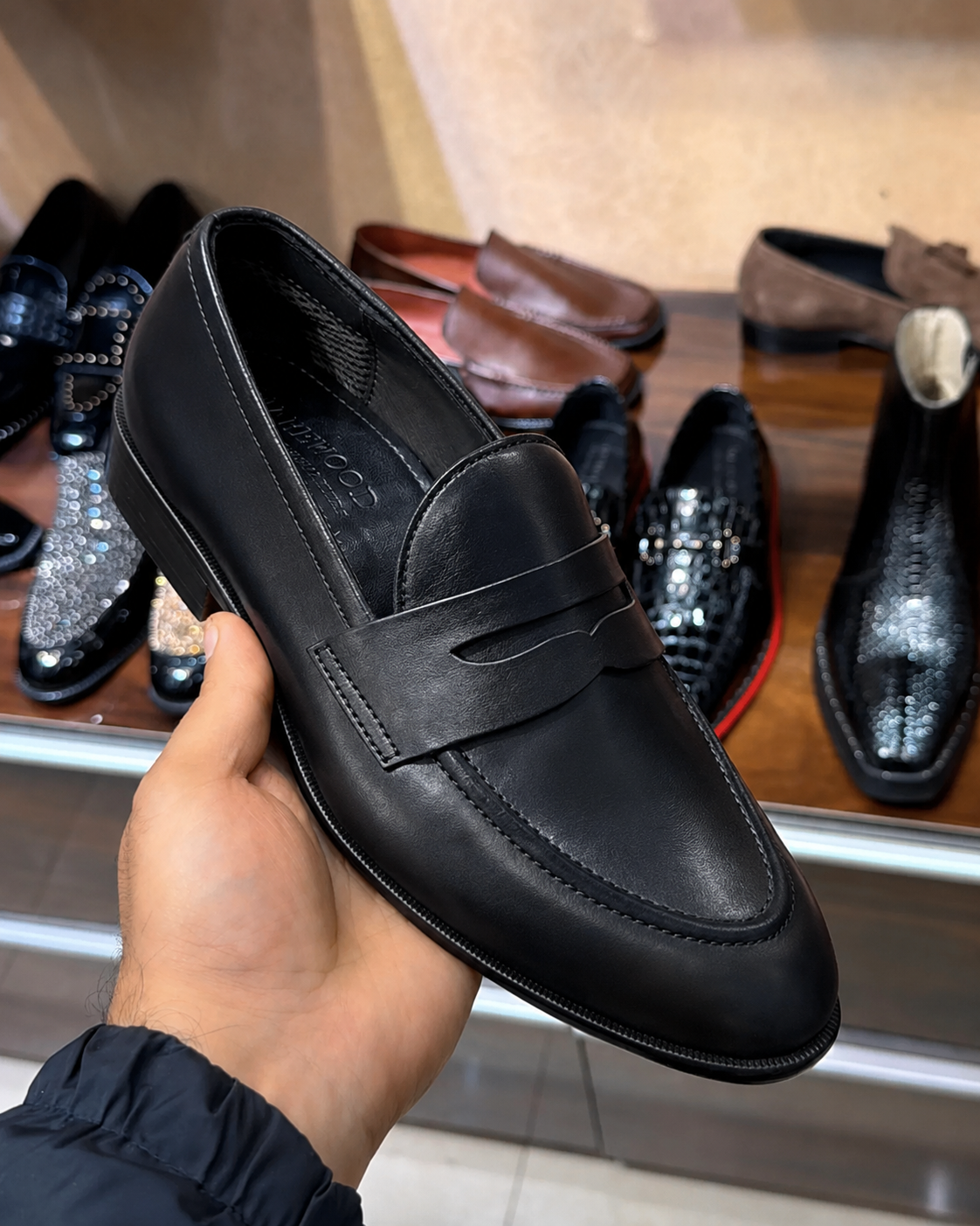 Black penny loafers for men with a round toe