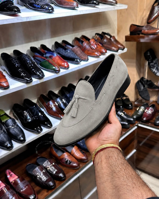 Grey suede loafers with tassels