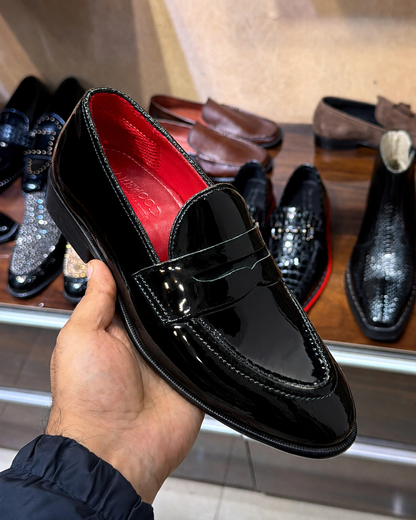 black patent leather penny loafers with a round toe