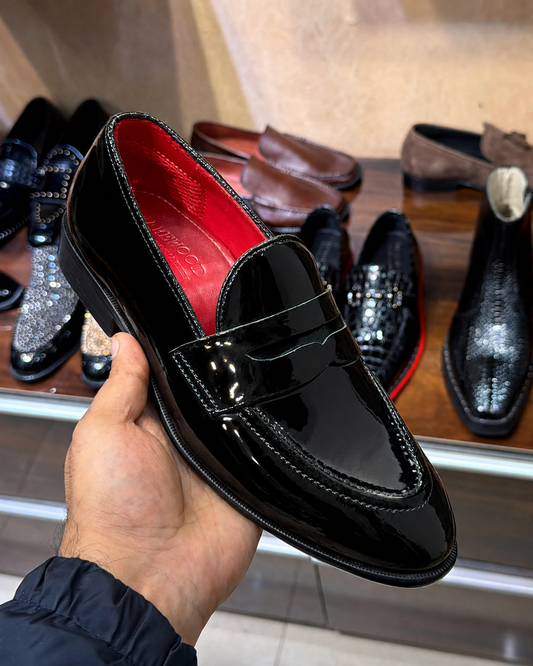 black patent leather penny loafers with a round toe